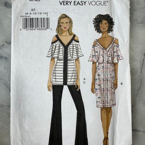May include: A Very Easy Vogue sewing pattern, V9238, featuring illustrations of two different off-the-shoulder tops and dresses. The pattern includes sizes A5 (6-8-10-12-14). The cover shows a black and white striped top with black pants and a floral print dress.