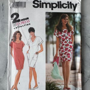 May include: A vintage Simplicity sewing pattern, number 7218, with dress designs. The cover includes the text "2 Hour Express Collection" and "Pattern/Patron". The pattern's cover is white with a barcode and the Simplicity logo.