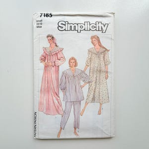 May include: A Simplicity 7185 sewing pattern envelope for size small 10-12 miss. The front features illustrations of three sleepwear options: a long pink nightgown, a striped pajama set, and a long floral nightgown, all with ruffled collars.