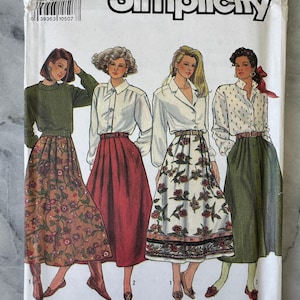 May include: Simplicity sewing pattern packet featuring illustrations of women's skirts and blouses. The packet includes the number 9876 and size N5 (10-18). The pattern's design includes a variety of skirt styles and blouse designs.