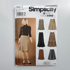 May include: A Simplicity 5914 sewing pattern envelope for 6 skirts made easy. The front features a photograph of a skirt in a tan textured fabric, alongside illustrations of six different skirt variations in various patterns and colours.