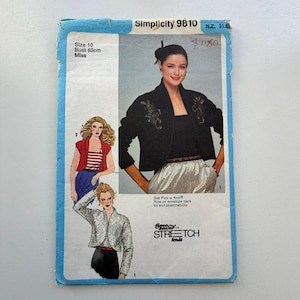 May include: Vintage Simplicity 9810 sewing pattern. The pattern features illustrations of women's jackets and tops. The envelope is blue with text and images, including the bust size of 83cm.