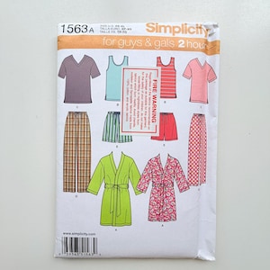 May include: A Simplicity 1563 sewing pattern envelope for lounge wear including V-neck shirts, tank tops, shorts, pants, and robes. The white paper envelope features illustrations of various garments in solid, striped, plaid, and floral patterns.
