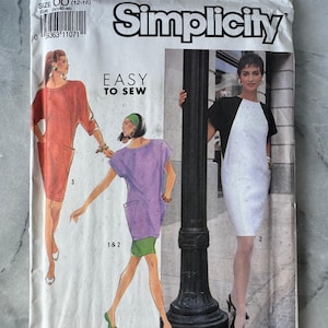 May include: A vintage Simplicity sewing pattern envelope with illustrations of dresses in red, purple, and white. The text "EASY TO SEW" is visible, along with the pattern number 7161 and size information. The size is indicated as OO (12-18).