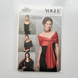 May include: Vogue Accessories sewing pattern 7161 featuring Elizabeth Gillet NYC designs. The envelope displays four variations of wraps and shawls worn over black dresses, including a red satin wrap, a sheer grey wrap, and black lace options.