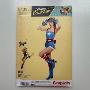 May include: A Simplicity sewing pattern envelope for a DC Comics Bombshells Stargirl costume, model 8433. The tan envelope features a graphic of a person wearing a blue and white star-patterned romper, red and white striped socks, and blue boots.