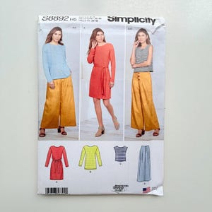 May include: Simplicity sewing pattern S8892 H5 featuring designs for a long-sleeve top, a belted dress, a sleeveless striped top, and wide-leg trousers with a button-front detail. The envelope displays illustrations of each garment style.