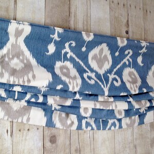 May include: A blue and white patterned roman blind with a white background and blue and grey ikat design.