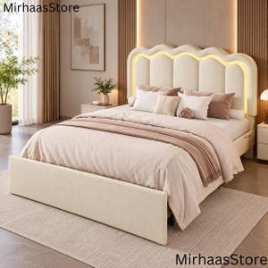 May include: A cream-colored upholstered bed frame featuring a scalloped headboard with integrated warm LED lighting. The bed is dressed in a light beige comforter, matching pillows, and a folded throw blanket, creating a neutral bedroom furniture set.