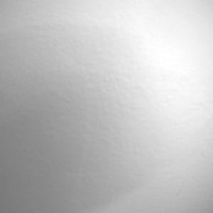 May include: A smooth, solid white surface with a subtle matte texture. The lighting creates a soft gradient effect, transitioning from a brighter, illuminated area on the right side to a slightly darker, shadowed tone on the left side of the frame.