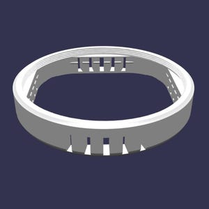 May include: A light gray circular ring component featuring a series of evenly spaced vertical rectangular cutouts along the outer edge and a ribbed interior texture with a horizontal bar detail across the top section of the inner circumference.