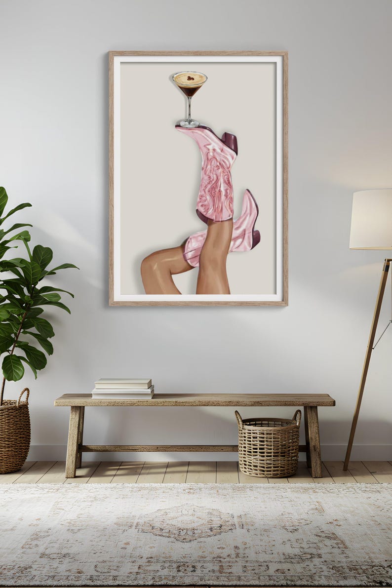 Cowgirl wall art with pink western boots holding an espresso martini glass on a soft neutral background for western glam decor.