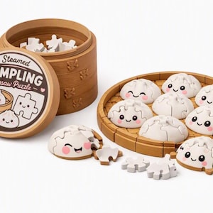 May include: A Steamed Dumpling Jigsaw Puzzle set featuring a brown bamboo-style container and lid with the text Steamed DUMPLING Jigsaw Puzzle. The set includes multiple white, rounded dumpling-shaped puzzle pieces with smiling faces and pink cheeks.