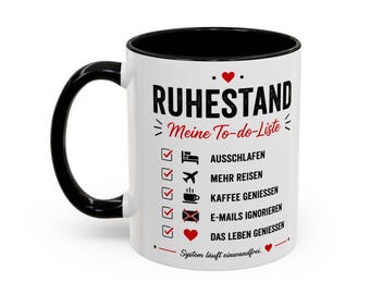 May include: A white ceramic mug with a black handle and interior, featuring a black and red graphic print. The text reads RUHESTAND Meine To-do-Liste, followed by a checklist with icons for sleeping, travelling, coffee, emails, and life.