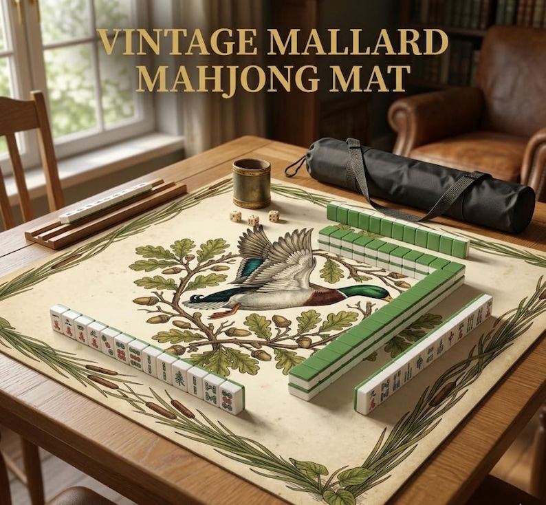 May include: A vintage Mahjong mat with a mallard duck illustration. The mat is beige with green and brown accents, and the text "VINTAGE MALLARD MAHJONG MAT" is displayed at the top. Mahjong tiles and accessories are arranged on a wooden table.