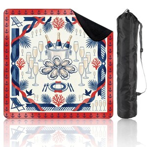 May include: A square picnic blanket with a nautical theme, featuring champagne bottles in an ice bucket, oysters, and champagne flutes. The design includes red, white, and blue accents, with a black carrying bag.