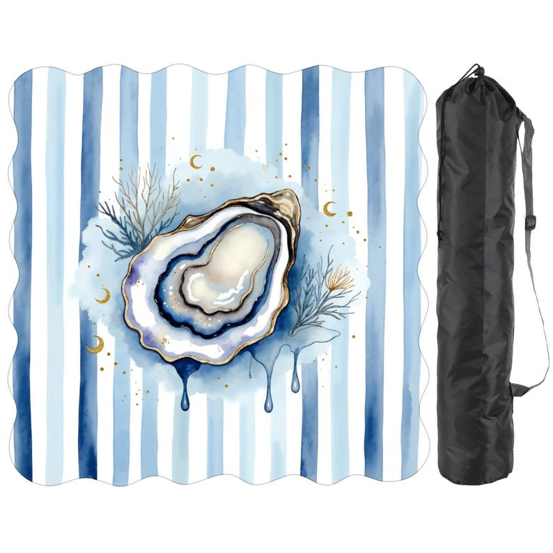 May include: A beach blanket featuring a watercolour oyster design on a blue and white striped background. The oyster has gold accents and a blue interior. A black carrying bag is included.