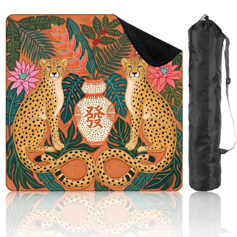 May include: A yoga mat featuring a vibrant design with two cheetahs, a vase with Chinese characters, and tropical foliage in shades of orange, green, and pink. Includes a black carrying bag.