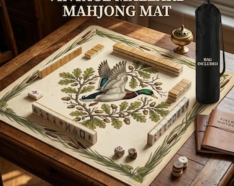 May include: Vintage Mahjong mat featuring a mallard duck illustration. The mat has a cream background with a green and brown border. Includes a black carrying bag. The game pieces and dice are visible on a wooden table.