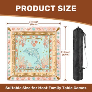 May include: A square table game mat with a dolphin and seashell design, measuring 31.5 inches (80cm) on each side. The mat is light blue, pink, and gold, with a black carrying bag. The text "PRODUCT SIZE" and "Suitable Size for Most Family Table Games" are displayed.