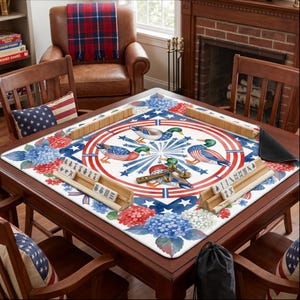 May include: A square wooden mahjong table with a decorative mat featuring ducks, stars, and stripes in red, white, and blue. The table is surrounded by wooden chairs and pillows with American flag designs.