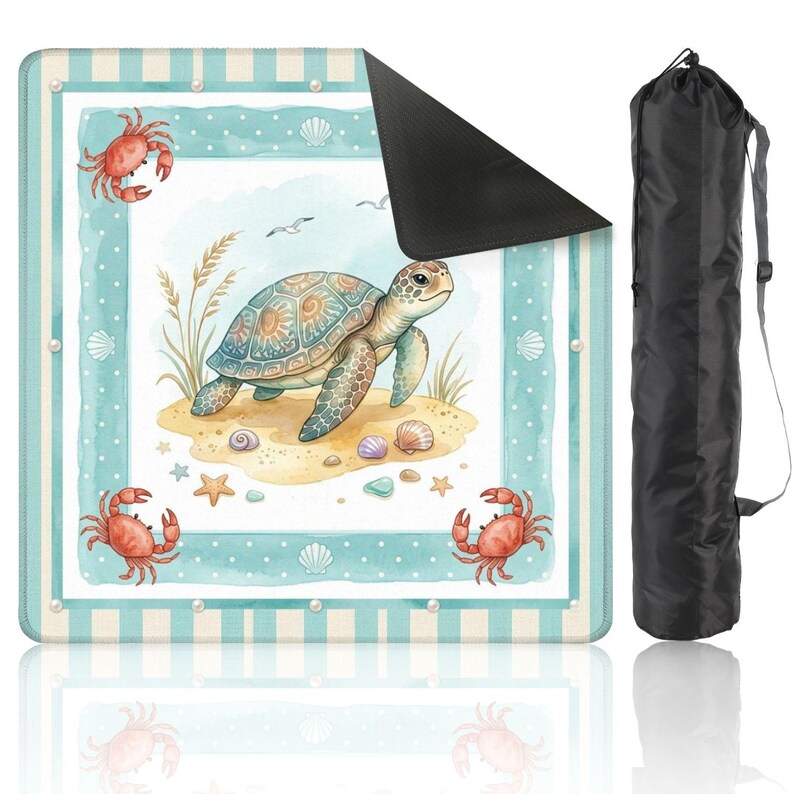 May include: A beach blanket with a watercolour design of a sea turtle on a sandy beach with seashells, starfish, and crabs. The blanket has a blue and white striped border and comes with a black carrying bag.