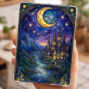 May include: A tablet case featuring a stained-glass design with a crescent moon, stars, and a castle. The artwork is set against a night sky with a river flowing through a landscape. The case has a protective frame with gold accents.