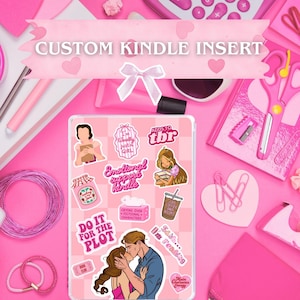 May include: A pink Kindle insert decorated with stickers. The stickers feature illustrations and text such as "CUSTOM KINDLE INSERT", "Emotional support Kindle", and "Do it for the plot". The theme is centered around reading and fictional characters.