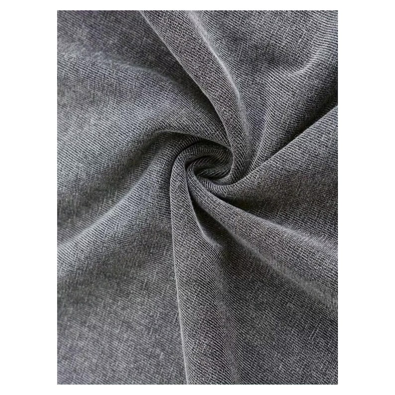 a close-up view of a wrinkled gray fabric, possibly denim or a similar type of material.
