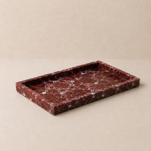 May include: A rectangular tray crafted from deep red stone with prominent white veining throughout the surface. The tray features a flat base and raised edges, showcasing a polished finish that highlights the natural patterns of the material.