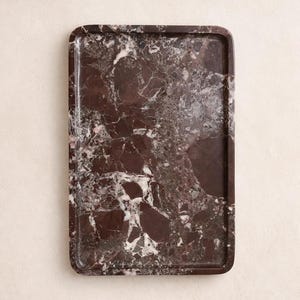 May include: Rectangular serving tray with a rich, dark burgundy marble pattern. The tray features rounded corners and a polished finish, showcasing a blend of burgundy, white, and grey veining. Ideal for serving or decorative display.