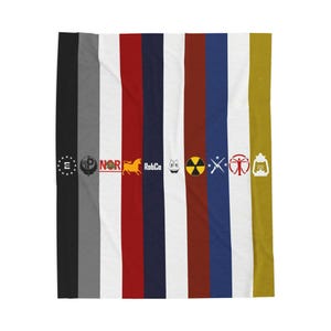 May include: A vertically striped blanket featuring various logos and symbols in black, gray, white, red, navy blue, brown, and yellow. The blanket has a variety of logos, including a gear, a horse, a smiling face, and a radiation symbol.