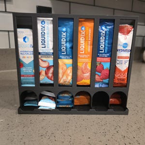 May include: A set of three ceramic nesting bowls in shades of blue, green, and white. The bowls feature a speckled glaze and a simple, modern design. The largest bowl measures approximately 6 inches in diameter.