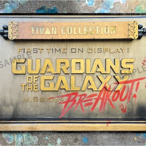 May include: A weathered metal sign with gold lettering that reads "TIVAN COLLECTION" and "GUARDIANS OF THE GALAXY MISSION: BREAKOUT!" The sign has a distressed look with red paint splatters and handprints.