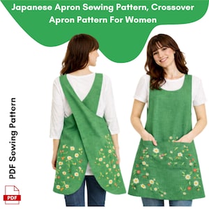 May include: Two women wearing green aprons with floral embroidery. The aprons have a crossover design and pockets. The image includes text that reads "Japanese Apron Sewing Pattern, Crossover Apron Pattern For Women" and "PDF Sewing Pattern".