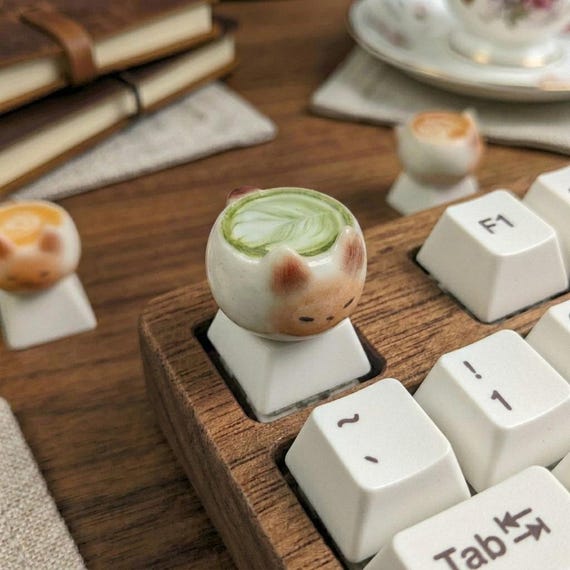 A hand-poured resin artisan keycap in matcha green — a tiny sculptural upgrade that instantly makes any mechanical keyboard feel one-of-a-kind.