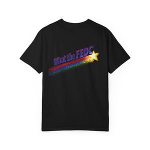 May include: Black t-shirt featuring the phrase "What the FEOC" in purple and yellow, with a rainbow streak and a gold star. The design is on the back of the shirt.