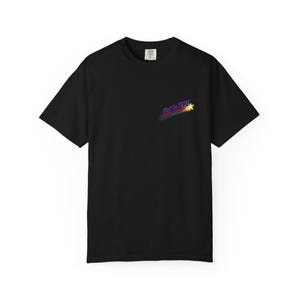 May include: Black t-shirt with the text "What the FED?" in a colorful, shooting star design. The shirt has short sleeves and a crew neck. A small tag is visible near the collar.