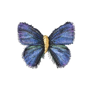 May include: A butterfly-shaped brooch featuring iridescent blue and purple frayed fabric wings with a textured, metallic gold-colored central body. The wings exhibit a fibrous, thread-like appearance with dark edges and a shimmering, multi-tonal finish.