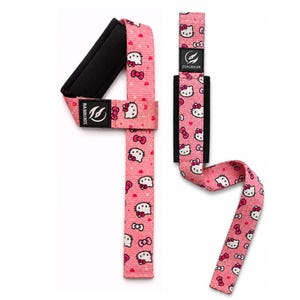May include: A pair of pink weightlifting straps featuring a repeating pattern of Hello Kitty faces and red bows. Each strap includes a black padded wrist support and a black label with the white text ZOKUGEAR printed on the surface.
