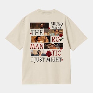 May include: A white ceramic mug with a black handle and the text "But First, Coffee" in a bold, black font. The mug is set against a blurred background, suggesting a cozy setting.