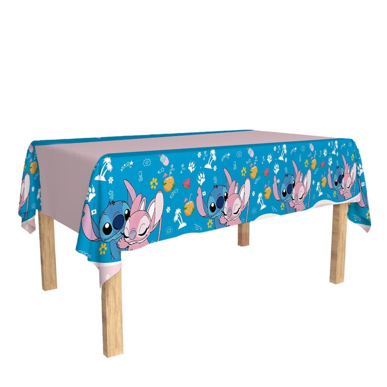 May include: A rectangular tablecloth featuring a light blue border with cartoon characters and a light pink center. The border has a repeating pattern of blue and pink characters, flowers, and fruit.