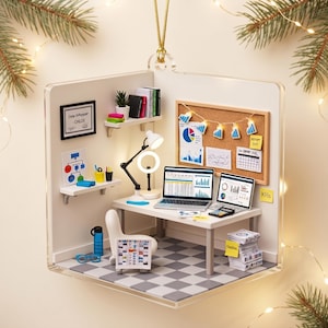 May include: A miniature office ornament featuring a desk with two laptops displaying data charts, a white chair, a cork board with graphs, a desk lamp, shelves with books, a framed certificate labeled Data Whopper CHLOE, and a stack of papers.