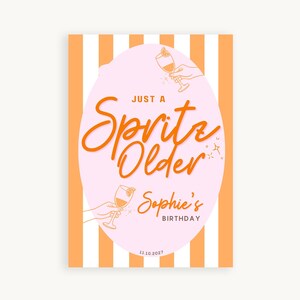 May include: A birthday poster with an orange and white striped background. The poster features a pink oval with the words "Just a Spritz Older" in orange script. Below, it reads "Sophie's Birthday" and the date.