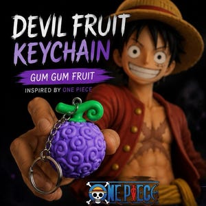Peut inclure: Un porte-clés Devil Fruit violet avec une tige verte, inspiré de One Piece. Le porte-clés est tenu devant une figurine de Luffy. Le texte sur l'image indique "Devil Fruit Keychain", "Gum Gum Fruit" et "Inspired by One Piece".