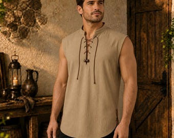 May include: A sleeveless tan tunic featuring a lace-up front with dark brown cord ties and a rounded hemline. The garment is constructed from a textured fabric and includes side slits at the bottom, providing a loose fit through the torso.