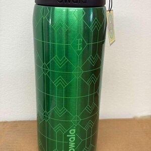 May include: Green Owala water bottle with a geometric pattern. The bottle has a green lid and a black band with the brand name. A small tag hangs from the bottle. The bottle is made of stainless steel.