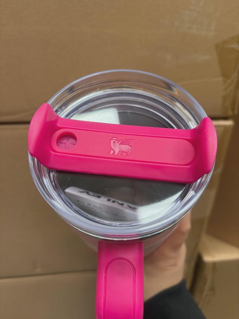 May include: A white ceramic mug with a black handle and the text "But First, Coffee" in a black, bold font. The mug is on a white surface.