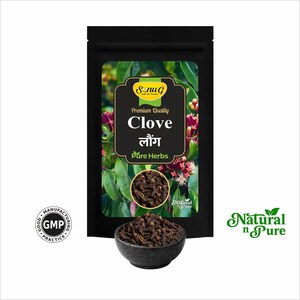 May include: A black package of "Clove" spices with a bowl of cloves in front. The package has a label with the text "Premium Quality Clove" and "Pure Herbs". The bowl is dark gray and the cloves are brown.
