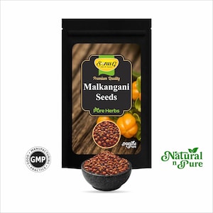May include: A black package featuring Malkangani Seeds, with a wooden background and a bowl of seeds in the foreground. The package has text that reads "Premium Quality Malkangani Seeds Pure Herbs". The image also includes the text "Natural n Pure".